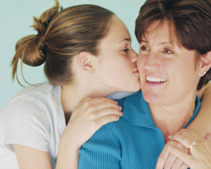 Teen Daughter Kissing Mother